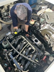 marine technician repairing a boat engine in connecticut