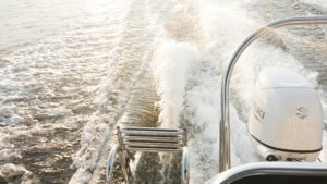 Boat engine in use in the water attached to the boat