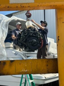 marine technicians working on repairing a boat engine